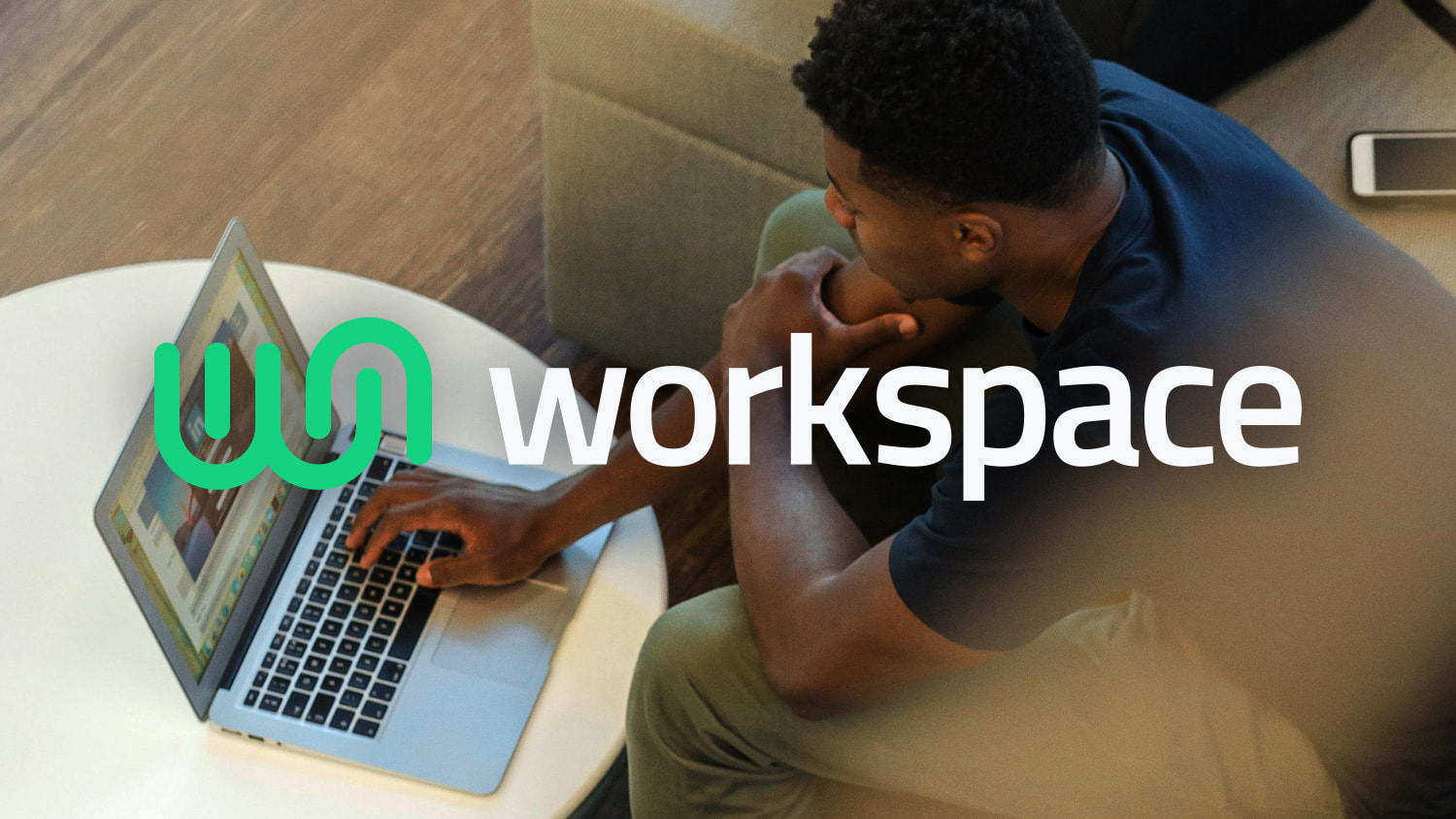 Cowork Workspace horizontal logo displayed over man sitting on a sofa browsing the web on a laptop